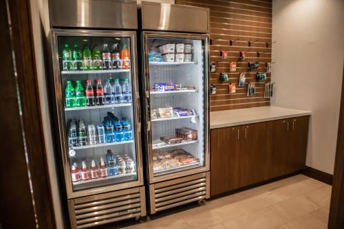 a refrigerator filled with lots of water and drinks at Holiday Inn Express & Suites - Gainesville I-75 by IHG in Gainesville