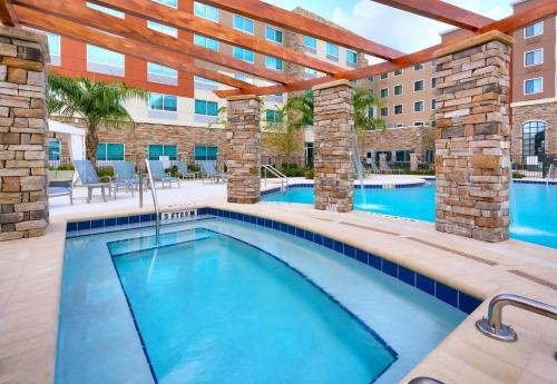 a swimming pool with a resort style swimming pool at Holiday Inn Express & Suites - Gainesville I-75 by IHG in Gainesville