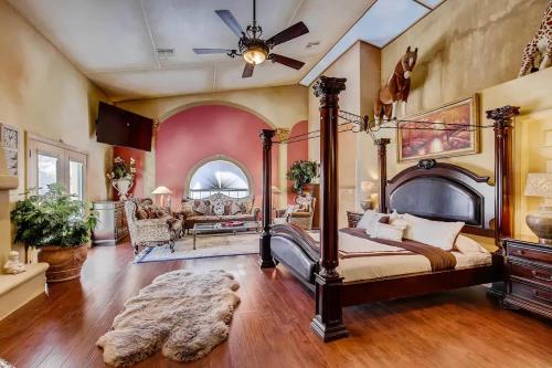 a bedroom with a large bed and a ceiling fan at Villa Gordal - Enormous Villa in Las Vegas with 39 Sleeps in Las Vegas