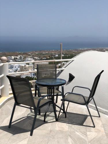 a table and two chairs sitting on a balcony at Lefteris Traditional Rooms in Fira