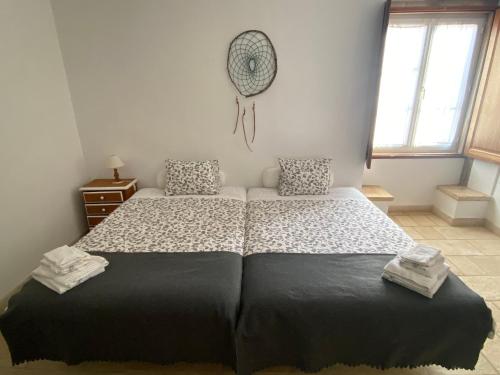 a bedroom with a large bed in a room at Quinta de São José dos Montes in Ferreira do Zêzere
