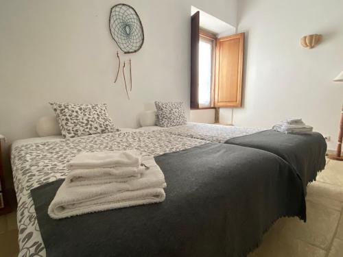 a bedroom with a bed with towels on it at Quinta de São José dos Montes in Ferreira do Zêzere