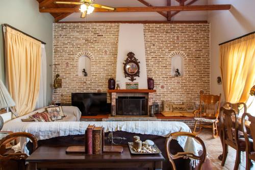 a living room with a couch and a brick wall at Elite Escape in Tsoukalades