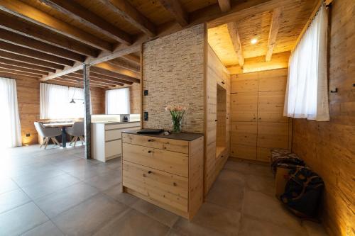 a kitchen and dining room with wooden walls at Chalet Schibenstoll in Wildhaus