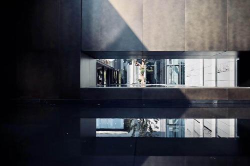 um reflexo de um edifício numa piscina de água em Intercontinental Shenzhen Dameisha Resort, an IHG Hotel em Shenzhen