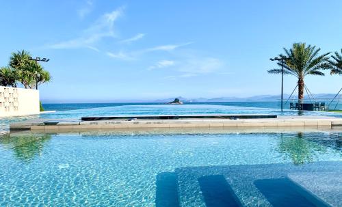 a swimming pool with a view of the ocean at Intercontinental Shenzhen Dameisha Resort by IHG in Shenzhen