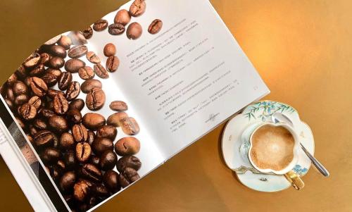 a book with a cup of coffee and a plate of nuts at Intercontinental Shenzhen Dameisha Resort by IHG in Shenzhen