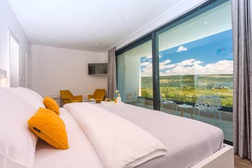 a bedroom with a large window and a large bed at Villa SUNRISE DREAM in Grubine