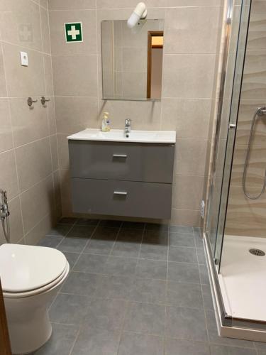 a bathroom with a toilet and a sink and a shower at Andorinha 2 bedroom apart-close to the sea-Algarve in Porches