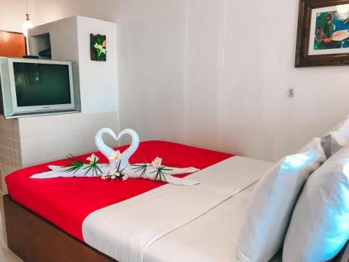 a hotel room with a bed with a red blanket at Aumpai Luxury in Lamai