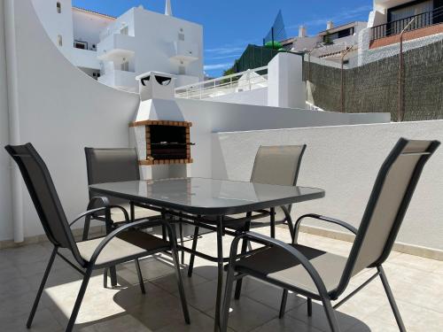 a table and chairs on a balcony with a heater at Borda d`Água, Praia da Oura in Albufeira