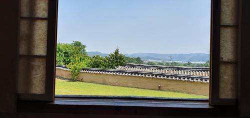 a window with a view of a train track at Ahndong Kimjongtaek Yangsodang in Andong