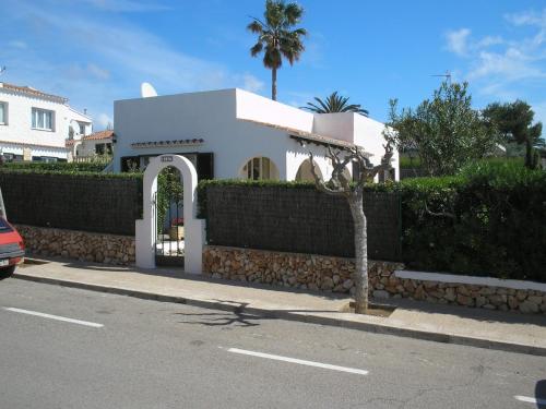 a white house with a fence and a tree at Villa Catieta in S'Algar