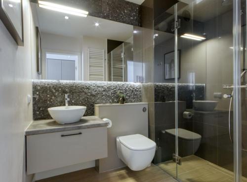 een badkamer met een toilet, een wastafel en een douche bij Wynalazek 2 by Homeprime in Warschau
