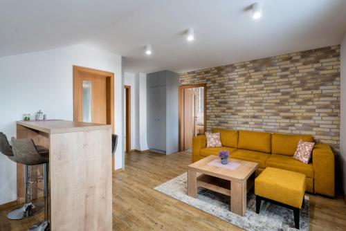 a living room with a couch and a table at Vila Anna - Ubytovanie Bešeňová in Bešeňová