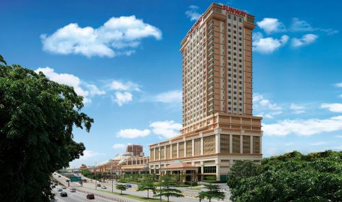 a tall building on a city street with a blue sky at Sunway Lagoon Hotel , formerly Sunway Clio Hotel in Kuala Lumpur