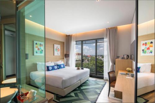 Ένα ή περισσότερα κρεβάτια σε δωμάτιο στο Aisana Hotel Korat