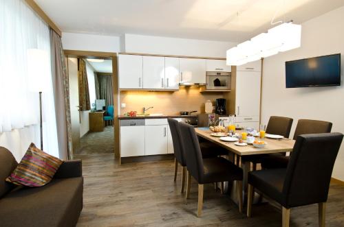 a dining room and kitchen with a table and chairs at Wolfs Aparts + More in Ischgl
