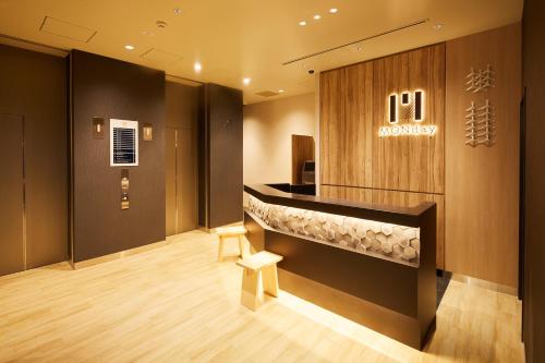 a lobby of a hospital with a reception counter at hotel MONday Asakusa in Tokyo