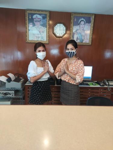 two women wearing face masks in a room at Siam Palace Hotel in Bangkok
