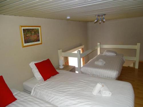 a bedroom with two beds with red and white sheets at Condo Gardens Leuven - Large One Bedroom in Leuven