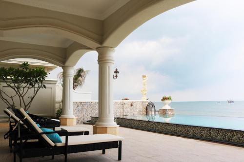 a porch with chairs and a view of the ocean at Lan Rung Beach Resort in Long Hai