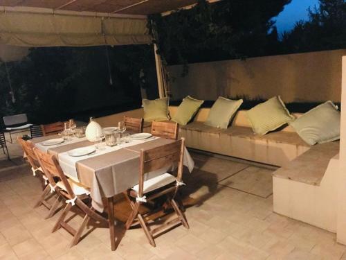a table with chairs and a couch in a patio at Case Graffeo in Menfi
