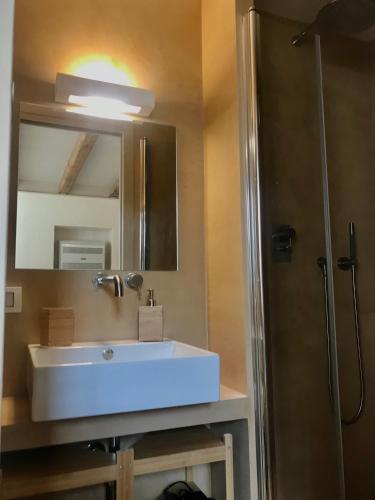 a bathroom with a white sink and a shower at Case Graffeo in Menfi