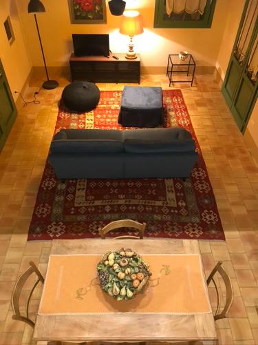 a living room with a blue couch on a rug at Case Graffeo in Menfi