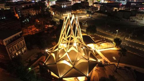 a lit up building in a city at night at Selfie's Boutique Hotel in Tiberias