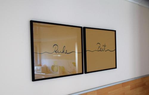 a picture on a white wall with three mirrors at Ferienwohnung auf dem Dorf, Külsheim in Külsheim