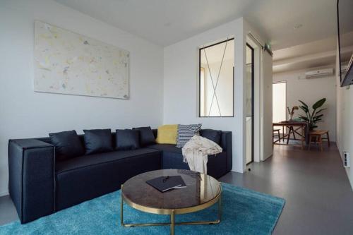 a living room with a couch and a coffee table at HOUS-AGALonomichi in Onomichi