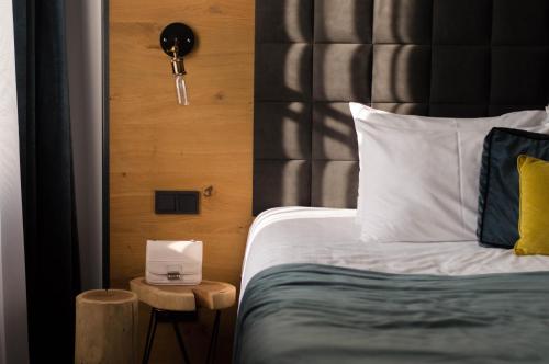a bedroom with a bed and a side table with a lamp at Hotel Rum Budapest in Budapest