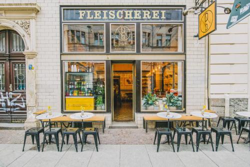 a group of tables and chairs in front of a store at theleaf - design apartment & café in Leipzig