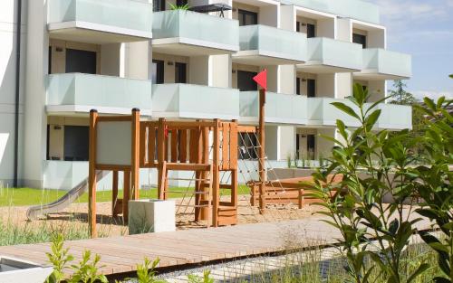 a building with a red arrow in front of it at Platinium Rewal Aparthotel 21,23 in Rewal