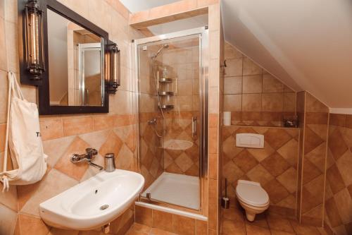 a bathroom with a shower and a sink and a toilet at Tabun in Gdańsk