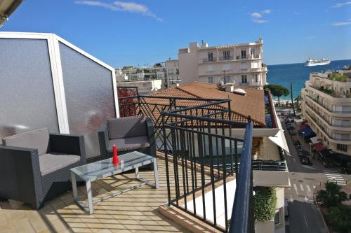 a balcony with two chairs and a table on a building at Nice apartment last floor with terrace and clear view on the sea in Cannes