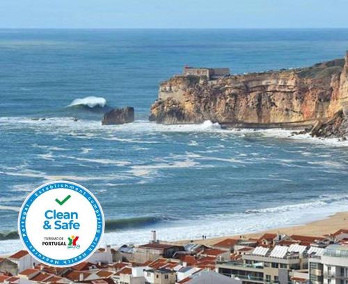a sign that says clean and safe next to the ocean at Hospedaria A Primorosa in Nazaré