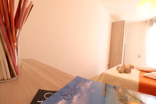 a bedroom with a bed and a book on the floor at Casa vacanze Nicole in Salento 5 posti in Otranto