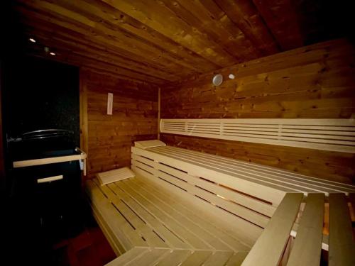 a wooden sauna with wooden benches in a room at Hotel Komperdell in Serfaus