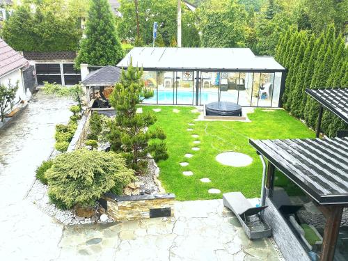 an aerial view of a garden with a swimming pool at Aspen in Kamenný Újezd