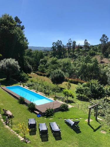 an image of a swimming pool in a yard at Quinta Da Ribeira in Ponte de Lima