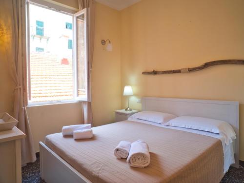 a bedroom with a bed with towels on it at 2 passi dal mare in Finale Ligure