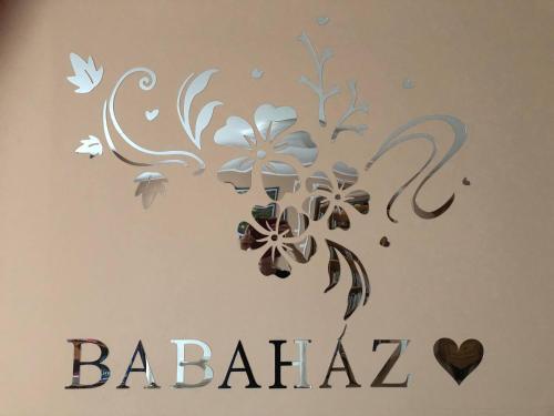 a drawing of flowers on a wall with the words babila at Babaház in Bodajk