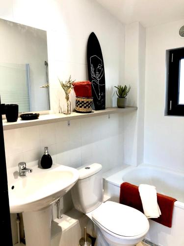 une salle de bain blanche avec des toilettes et un lavabo dans l'établissement Résidence « Au passage coloré », à Amiens