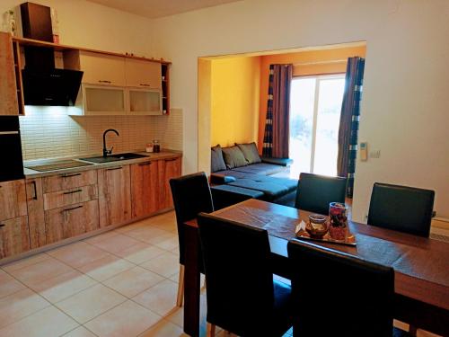 a kitchen and a dining room with a table and chairs at Apartment Maxim in Primošten
