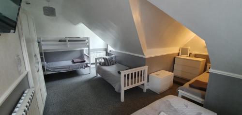 ein kleines Zimmer mit einem Bett und einem Kinderbett in der Unterkunft The Aldor in Skegness