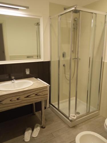 a bathroom with a shower and a sink at Hotel Miramare in Marina di Ragusa