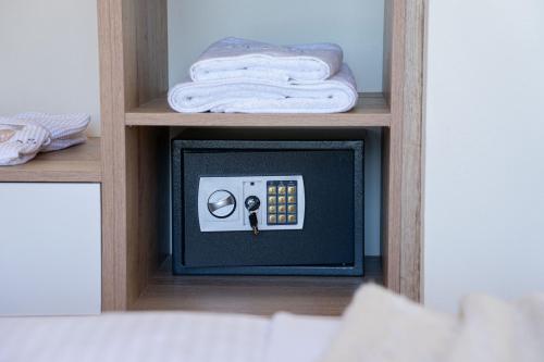 a small tv in a shelf with a towel at Diosas Luxury Villas in Pilaroú