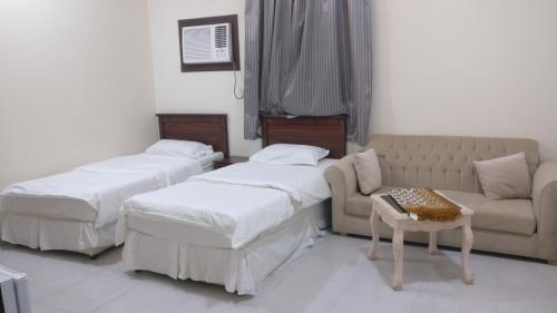 Postel nebo postele na pokoji v ubytování Al Basam Furnished Units